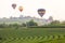 Flying hot air balloon over the mountains and tea plantation