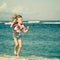 Flying jumping beach girl at blue sea shore