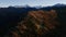 Flying in the mountains, autumn forest and mountain tops in the snow