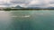 Flying over the beach with local and tourist people in Mauritius, Flic en Flac area. Many yacht and boats in water