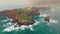 Flying over bizarre brown-green rocks of Ponta de Sao Lourenco, Madeira island, Portugal. Atlantic ocean waves crashing