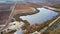 Flying over blueberry fields with irrigation pond. Blueberry plantation. Aerial footage