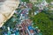 Flying over a busy paradise island harbor on a beautiful summer day. Remote harbor village is swarmed by tourist boats going on