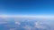 Flying over clouds - hyperlapse shot from airplane window