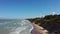 Flying Over Coastline Baltic Sea Ulmale Seashore Bluffs Near Pavilosta Latvia and Landslides With an Overgrown, Rippling Cave Dott