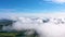 Flying over through the fluffy clouds layers. Amazing timelapse of soft white clouds moving on the clear sky