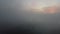 Flying over foggy lake early morning at sunrise. Drone video.