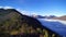 Flying over a forest on a pyrenean mountain, next to a sea of clouds. The snowy Montcalm mount appears in the background.