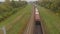 Flying over a freight train moving in the countryside