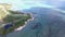 Flying over the golf field in Mauritius. Indian Ocean and beach is below. Yacht and boats on coastline