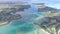 Flying over the golf field in Mauritius. Indian Ocean and beach is below. Yacht and boats on coastline