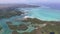 Flying over the golf field in Mauritius. Indian Ocean and beach is below. Yacht and boats on coastline