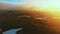 Flying over the green valley. Sunset in the mountains
