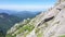 Flying over high mountain ridge. Aerial drone view of white sedimentary rocks