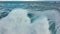 Flying over huge wave in atlantic ocean. Aerial filming breaking surf with foam. Powerful stormy sea or ocean waves