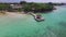 Flying over the Indian Ocean in Mauritius with luxury yacht and boats. Looking straight down to water. Albion area.