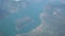 Flying over the Iseo lake during summer season. Montisola island. Aerial view from the airplane window