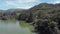 Flying over a lake in a vast valley of the Western Ghats mountain range near the countryside tea plantation town of Munnar, India.