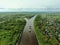 Flying over a large cargo ship with open holds sailing down a calm river surrounded by forest. Carriage of goods by river.