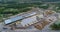 Flying over a large sawmill, the work of machinery on sawmills, flying over the warehouse of logs at the sawmill