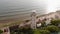 Flying over the lighthouse on a cliff of the coast near the sea. Aerial shot