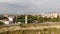 Flying over the lighthouse on a cliff of the coast near the sea. Aerial shot