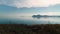 Flying over mirror water on background of mountains. Shot. Picturesque view of sea surface with reflection of blue sky