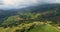 Flying over the mountains and small houses with forest