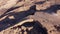 Flying over a natural volcanic rock arch formation in desertic landscape in Tenerife, Canary islands, Spain.