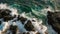 Flying Over Rocky Ocean Shore As Wave Splashes