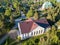 Flying over roofs of Russian village with wooden houses. Leningrad region, Russia.