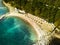 Flying over the sea and beach in a mountainous forest area.