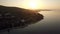 Flying over sea and Trikorfo Beach coastline at sunset, Greece