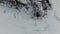 Flying over snow covered houses along frozen lakefront