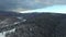 Flying over snowy hills and forest