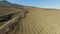 Flying over spring farm fields. Shot. Top view of farm fields with new plantings and bare ground. Beautiful yellow