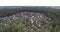 Flying over summer village with wooden houses. Aerial view.