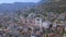 Flying over sunny town Alanya in Turkey located by the Mediterranean sea. Art. Aerial view of the mountain slope covered