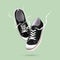 Flying pair black sneakers isolated on bright green background. Fashionable stylish sports casual shoes. Creative minimalistic