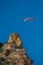 Flying of paraglider above autumn rocky mountains