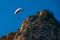 Flying of paraglider above autumn rocky mountains