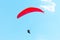Flying paraglider on blue sky background