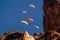 Flying of paragliders above autumn rocky mountains