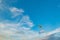 A flying paramotor on a vibrant sky with cloud.