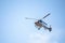 Flying passenger helicopter and blue sky