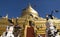 Flying pigeons in front of golden stupa