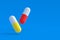 Flying pills on blue background. Concept of healthcare and medical