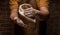 Flying pizza dough with flour scattering in a freeze motion of a cloud of flour midair on black. Cook hands kneading dough. copy