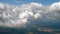 Flying in a plane through the fluffy, snow-white clouds. Spectacular view from the window of an airplane. Aircraft flies