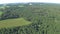 Flying on powered parachute over the forest and field in Belarus. The view from high. Point of view, hand held